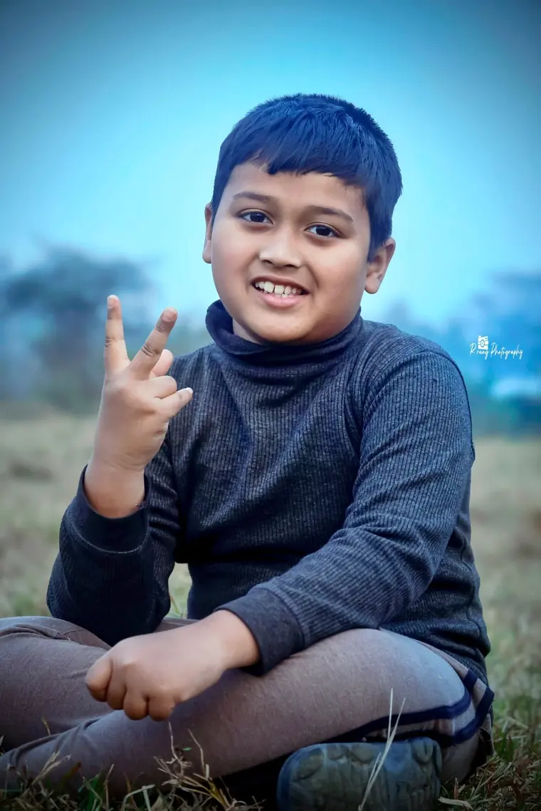 Boy in a blue sweater, out in the fields