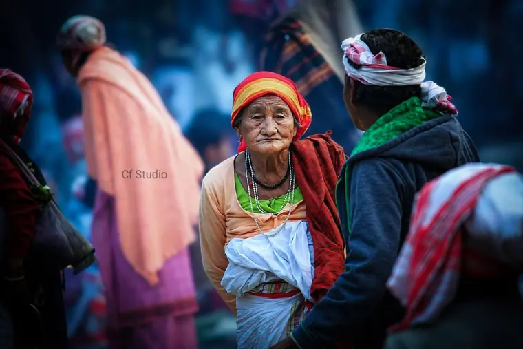 Elder woman in traditional dress at a village gathering