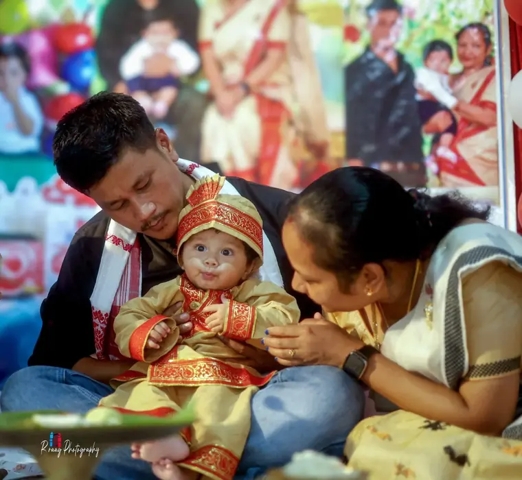 Parents blessing their baby at the ceremony