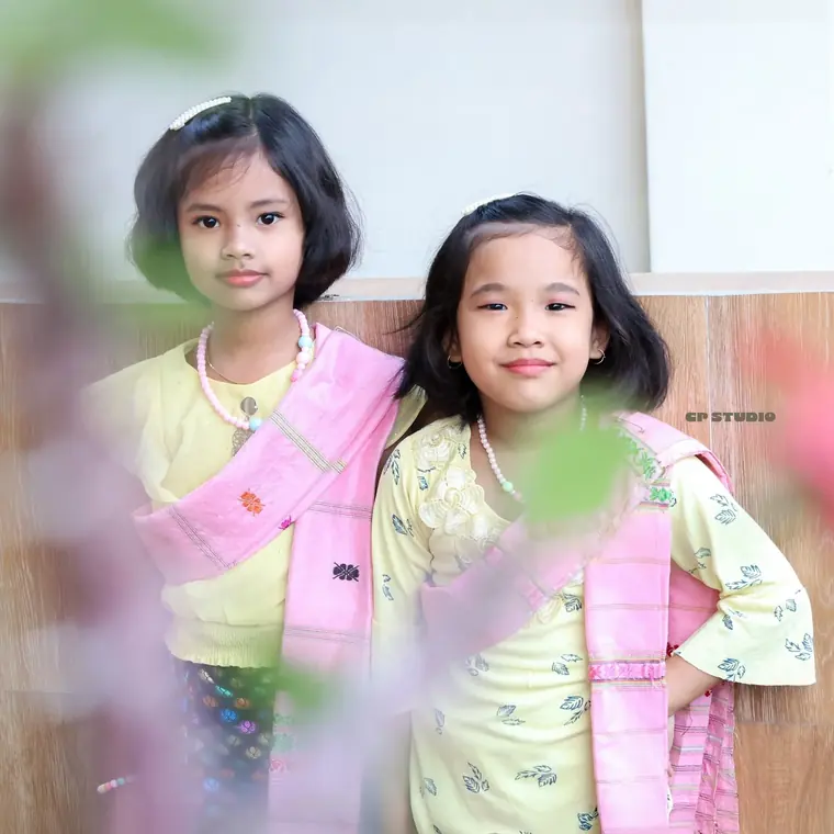 Sisters in soft pink, quiet frame