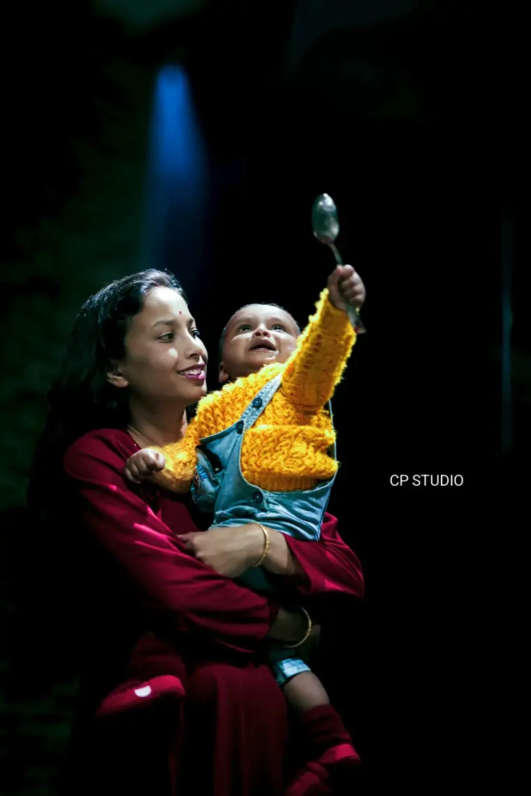 Mother lifting her baby into the evening light