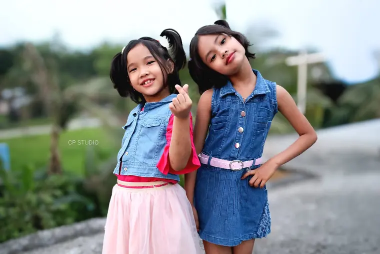 Two girls posing on the village road
