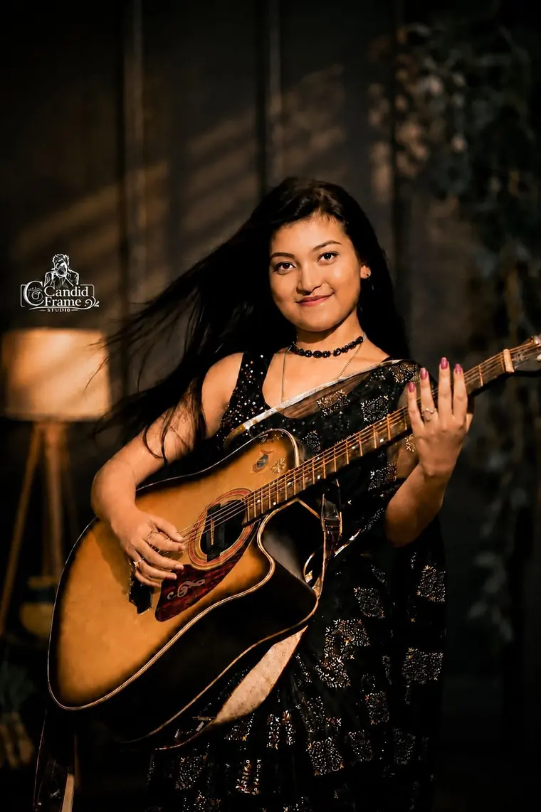 Portrait with a guitar, low key