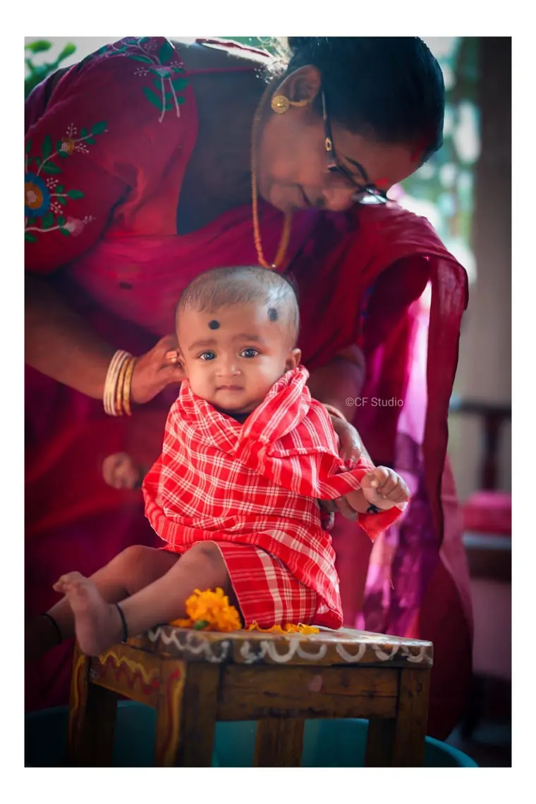 Baby seated on a carved chair
