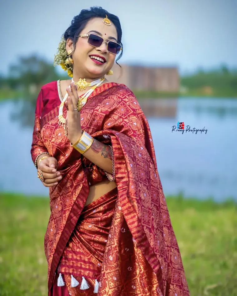 Bride in red saree beside the water