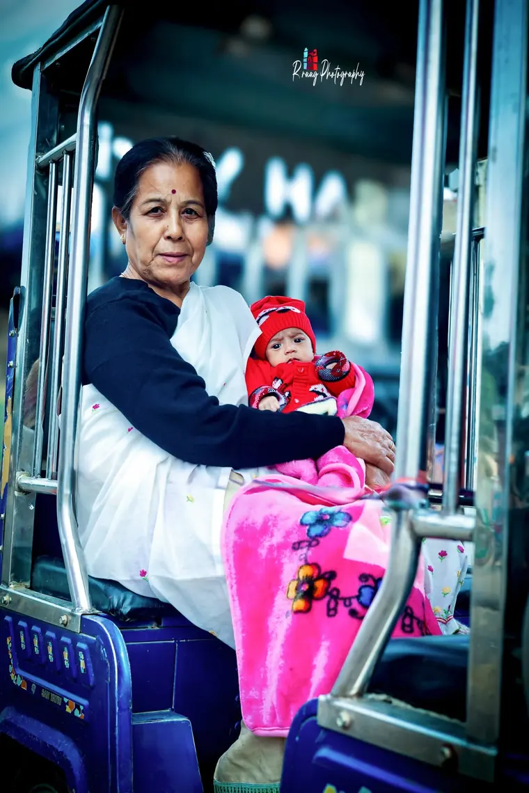 Grandmother holding the child on the way home
