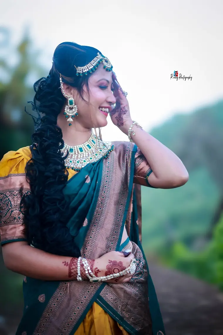 Bride in green and gold with full traditional jewellery