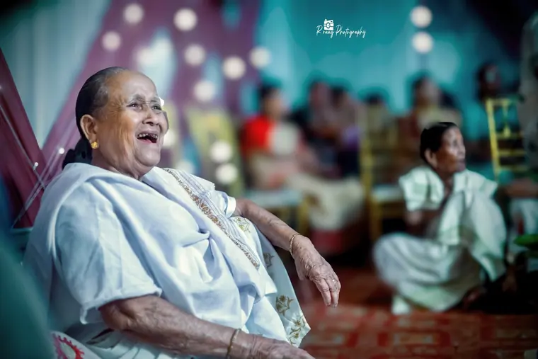 Elder woman laughing mid-conversation